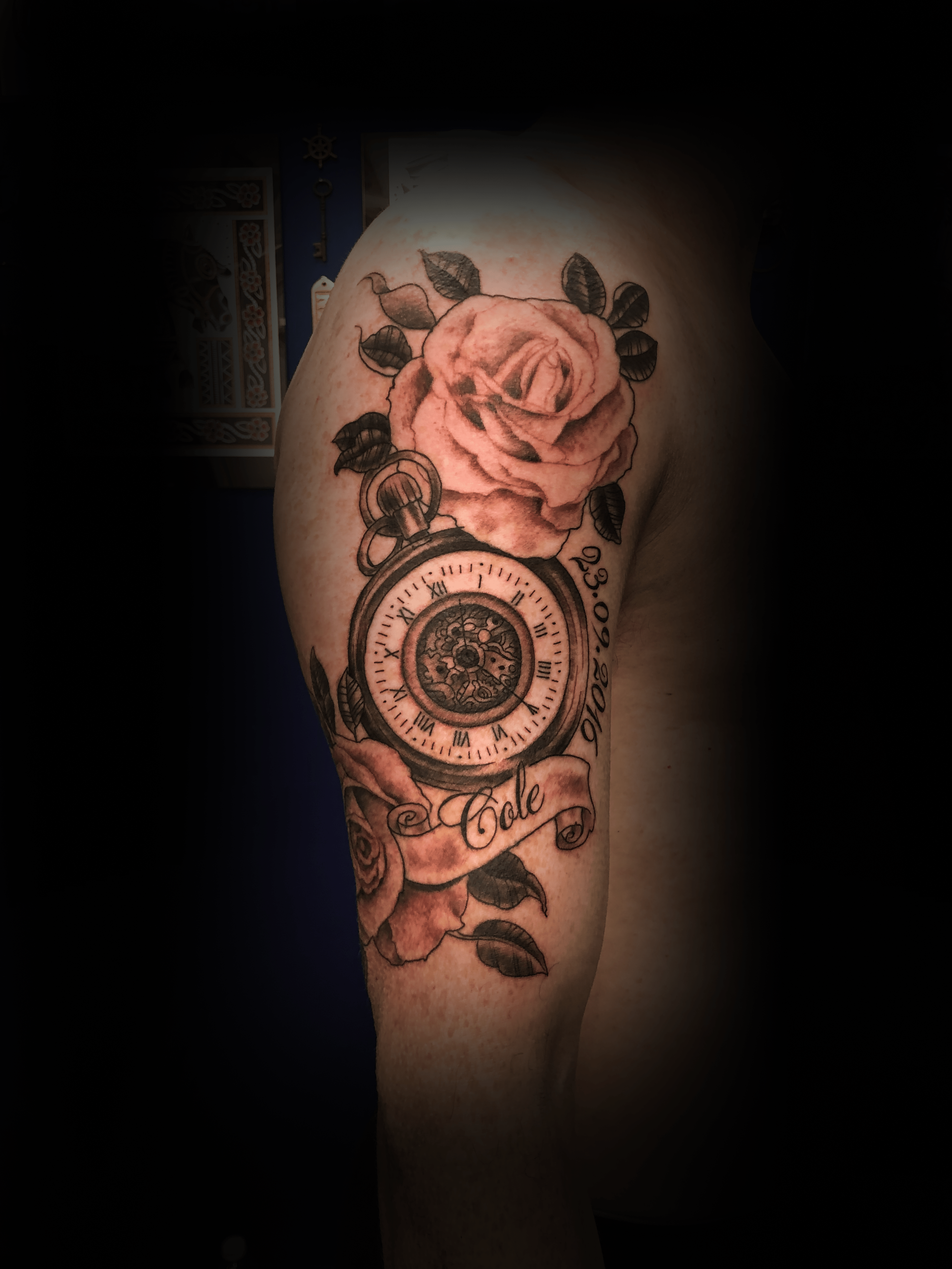 An image of a custom tattoo from Kevin Younger's Lucky Cat Tattoo Parlour: a design featuring an old pocket watch with roses