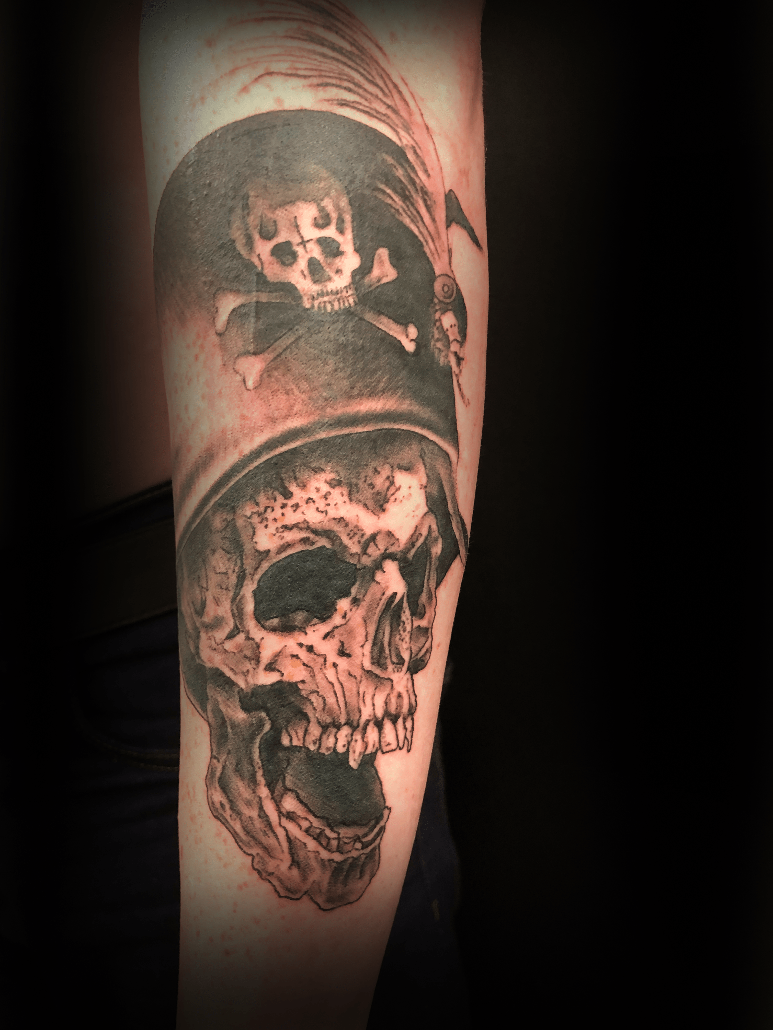 An image of a custom tattoo from Kevin Younger's Lucky Cat Tattoo Parlour: a design featuring a black and grey dead pirate skull with hat